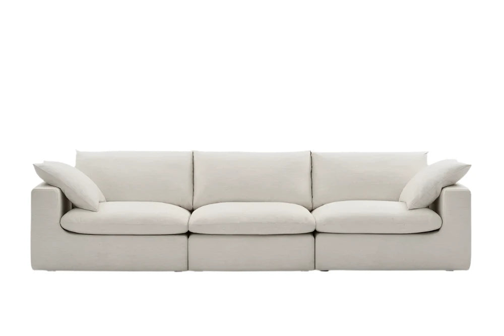 A beige three-seater sofa with a minimalist design and plush cushions.